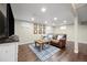 Finished basement with a stylish leather sofa, wood floors, and recessed lighting at 10694 E Dorado Ave, Englewood, CO 80111