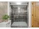 Modern tiled shower with glass enclosure and updated fixtures in bathroom at 10694 E Dorado Ave, Englewood, CO 80111