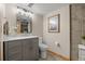 Well-lit bathroom with gray vanity, marble countertop, and decorative accents at 10694 E Dorado Ave, Englewood, CO 80111