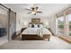 Bright bedroom features a ceiling fan, carpet, and a wooded headboard bed frame at 10694 E Dorado Ave, Englewood, CO 80111