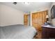 Comfortable bedroom featuring wooden closet doors and neutral decor at 10694 E Dorado Ave, Englewood, CO 80111