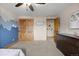 Open bedroom featuring closet, dresser, trimwork, ceiling fan and adjoining room at 10694 E Dorado Ave, Englewood, CO 80111