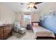 Cozy bedroom with mountain mural, chair, and bed, offering a comfortable space at 10694 E Dorado Ave, Englewood, CO 80111