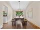Dining room featuring farmhouse table with benches, modern light fixture and backyard view at 10694 E Dorado Ave, Englewood, CO 80111