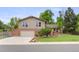 Charming two-story home with a brick-accented facade, attached garage, and well-manicured front lawn at 10694 E Dorado Ave, Englewood, CO 80111