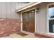 Inviting front entrance with double doors, brick accents, a 'welcome' mat, and stylish exterior lighting at 10694 E Dorado Ave, Englewood, CO 80111