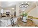 Kitchen with stainless appliances and granite countertops open to the dining area with chandelier lighting at 10694 E Dorado Ave, Englewood, CO 80111