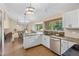 Charming kitchen and dining space with granite counters, stainless appliances, and a sunlit eating area at 10694 E Dorado Ave, Englewood, CO 80111