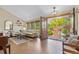 Bright living room with hardwood floors, neutral furniture, decor and access to backyard through large open door at 10694 E Dorado Ave, Englewood, CO 80111