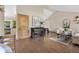 Open-concept living room with hardwood floors, neutral decor, piano, and an adjacent kitchen at 10694 E Dorado Ave, Englewood, CO 80111