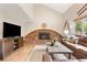Inviting living room with vaulted ceilings, brick fireplace, and rustic wood accents at 10694 E Dorado Ave, Englewood, CO 80111