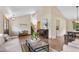 Open-concept living room with hardwood floors, neutral decor, piano, and adjoining dining and kitchen spaces at 10694 E Dorado Ave, Englewood, CO 80111
