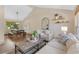 Spacious living room with vaulted ceilings, neutral furniture, decor, and natural light with dining area at 10694 E Dorado Ave, Englewood, CO 80111