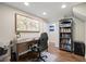 Bright office space with a large desk, bookshelf, and world map wall art at 10694 E Dorado Ave, Englewood, CO 80111