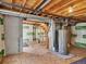 Unfinished basement featuring a hot water heater, wood beams, and concrete walls at 5280 E 128Th Way, Thornton, CO 80241