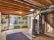 View of the unfinished basement, including a water heater, insulation, and small window at 5280 E 128Th Way, Thornton, CO 80241