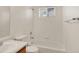 Bright bathroom features a shower and tub combination with a window for natural light at 5280 E 128Th Way, Thornton, CO 80241