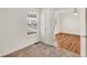 Carpeted bedroom with white walls and view to a wood floor room and double hung window at 5280 E 128Th Way, Thornton, CO 80241