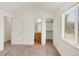 Bedroom showcasing neutral carpet, large window, closet and bathroom access at 5280 E 128Th Way, Thornton, CO 80241