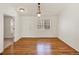 Dining room featuring beautiful hardwood floors, natural light, and white painted walls at 5280 E 128Th Way, Thornton, CO 80241