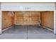 Spacious two car garage interior with storage shelves and concrete floor at 5280 E 128Th Way, Thornton, CO 80241