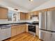 Bright kitchen features stainless steel appliances, light wood cabinets, and dark countertops at 5280 E 128Th Way, Thornton, CO 80241