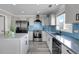 Bright kitchen featuring stainless steel appliances and a backsplash at 9593 Racoon Pl, Littleton, CO 80125