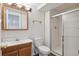 Bathroom featuring single vanity, tile floors, updated lighting, shower and a large vanity mirror at 10535 Holyoke Dr, Parker, CO 80134