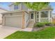 Charming two-story home features a bay window, a front door, and a two-car garage at 10535 Holyoke Dr, Parker, CO 80134