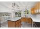 Bright kitchen featuring laminate countertops, stainless steel sink, and a pendant light at 10535 Holyoke Dr, Parker, CO 80134