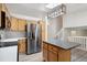 Well-equipped kitchen with stainless steel refrigerator and center island with barstool seating at 10535 Holyoke Dr, Parker, CO 80134