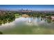 Aerial view of a lake and a building in the center with the city skyline behind it at 3016 N Franklin St, Denver, CO 80205