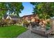 Landscaped backyard with patio, garden, lounge chairs, and charming exterior brick building at 3016 N Franklin St, Denver, CO 80205