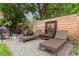 Relaxing backyard lounge area with wicker chaise lounges, decorative accents, and a privacy fence for ultimate tranquility at 3016 N Franklin St, Denver, CO 80205