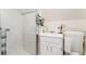Cozy bathroom featuring a tiled shower, white vanity, neutral decor, and a heated towel rack at 3016 N Franklin St, Denver, CO 80205