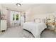 Charming bedroom with a white bed, sheer curtains, decorative pillows, and a decorative mirror at 3016 N Franklin St, Denver, CO 80205