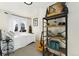 Sunlit bedroom featuring a bed, decorative shelves with personal items, and a view of the outside at 3016 N Franklin St, Denver, CO 80205