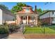 Charming two-story brick home featuring a cozy front porch and well-manicured lawn at 3016 N Franklin St, Denver, CO 80205