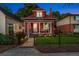 Charming two-story brick home featuring a cozy front porch and well-manicured lawn at 3016 N Franklin St, Denver, CO 80205