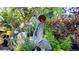 Artistic garden with decorative statues, lush plants, and unique accents, creating a serene and visually appealing outdoor space at 3016 N Franklin St, Denver, CO 80205
