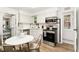 Bright kitchen with stainless steel appliances, white cabinets, open pantry, and a round table at 3016 N Franklin St, Denver, CO 80205