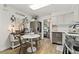 Well-lit kitchen with modern appliances, white cabinets, and a cozy breakfast nook for casual dining at 3016 N Franklin St, Denver, CO 80205