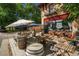 Cafe exterior with wooden tables, chairs and umbrellas for outdoor seating in front of the building at 3016 N Franklin St, Denver, CO 80205