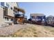 Spacious backyard with a wooden fence and mature trees, offering privacy and a great space for outdoor activities at 1280 Galactic Pl, Castle Rock, CO 80108