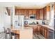 Kitchen with wood cabinets, stainless steel appliances, granite countertops, and an island at 1280 Galactic Pl, Castle Rock, CO 80108