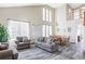 Spacious living room featuring high ceilings, lots of windows, and wood-look flooring at 1280 Galactic Pl, Castle Rock, CO 80108
