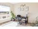 Bright office space with a large window and a view, featuring a stylish desk, chair, and decorative wall art at 1280 Galactic Pl, Castle Rock, CO 80108