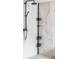 Modern shower showcasing a sleek shower-head system and wall-mounted accessories at 1280 Galactic Pl, Castle Rock, CO 80108