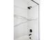 Shower with a new showerhead, marble tile, and sleek black fixtures at 1280 Galactic Pl, Castle Rock, CO 80108