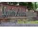 Attractive stone signage for Sapphire Pointe community with manicured landscaping and a water feature at 1280 Galactic Pl, Castle Rock, CO 80108